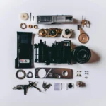 Flat Lay Photography of Black and Gray Components on White Surface
